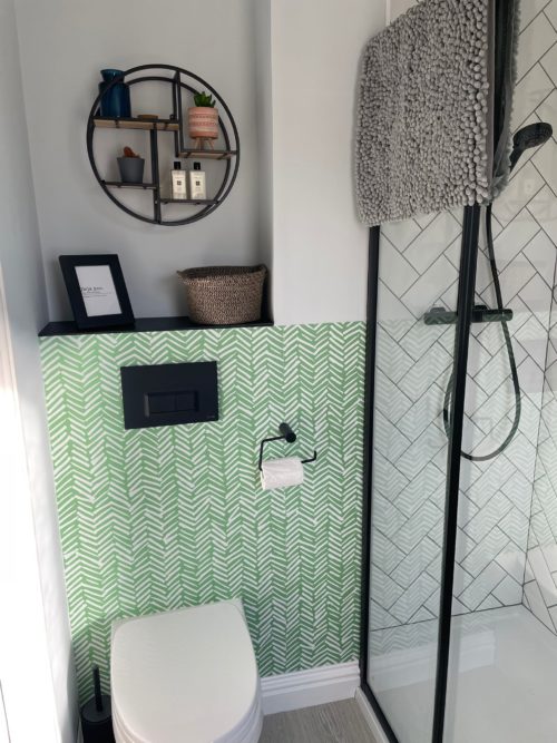 Ensuite bathroom, green wallpapered walled with toilet