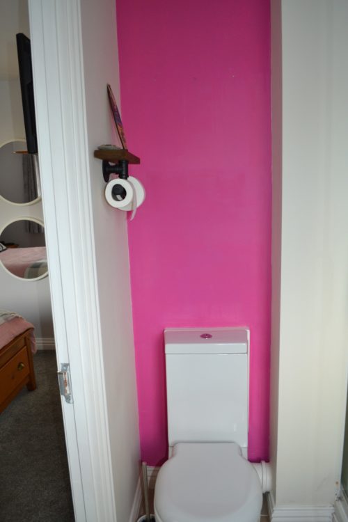 Ensuite bathroom, painted pink wall with toilet