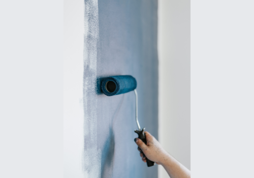 Painting a room with blue paint and roller