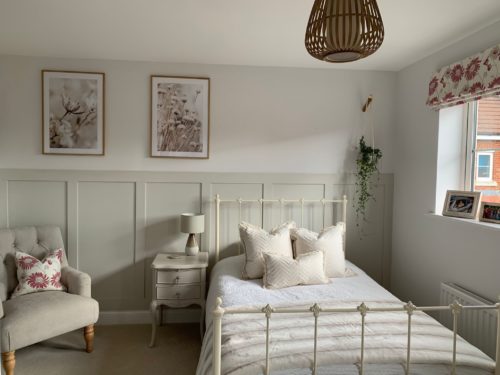 Guest Bedroom with iron bed, panelled feature wall