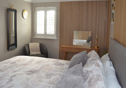 Bedroom with wood panelling showing a room prepared with home staging